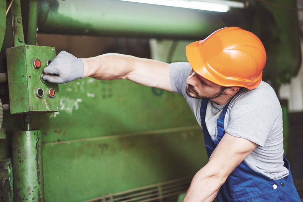 Industrial worker working with lathe in the metalworking industry.